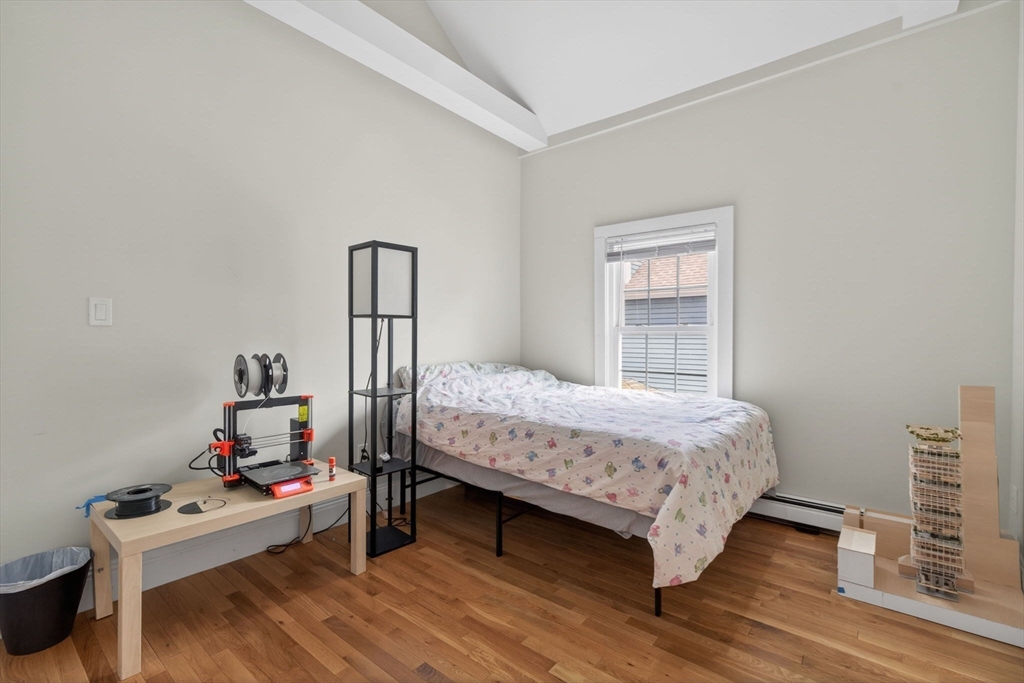 50 Roberts Road Cambridge, MA 02138 - Photo 16 of 25 a bedroom with a bed and wooden floor
