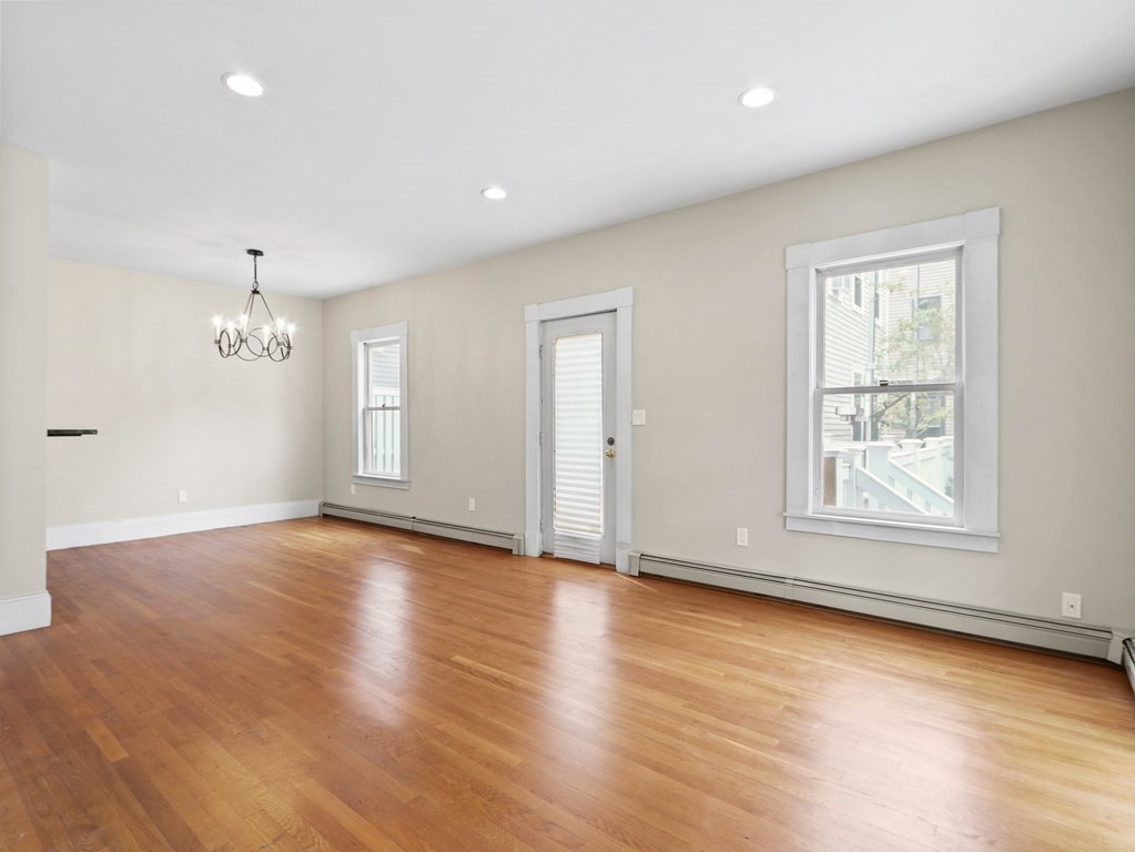 50 Roberts Road Cambridge, MA 02138 - Photo 2 of 25 an empty room with wooden floor and windows