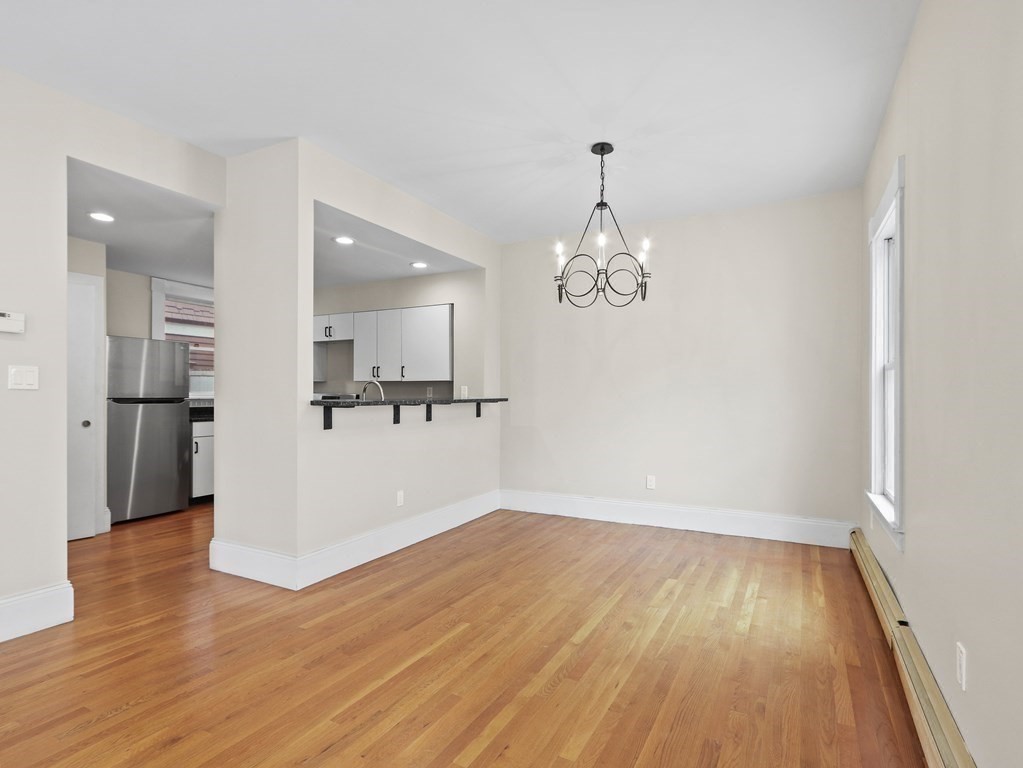 50 Roberts Road Cambridge, MA 02138 - Photo 4 of 25 a view of kitchen and empty room with wooden floor
