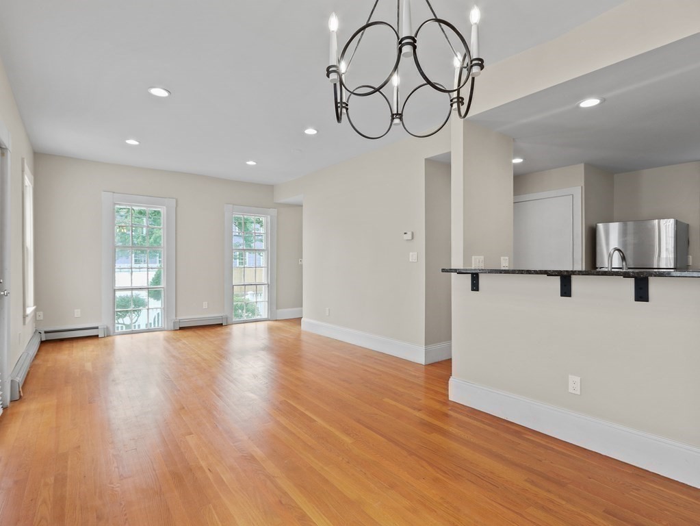 50 Roberts Road Cambridge, MA 02138 - Photo 6 of 25 a view of empty room with wooden floor and fan