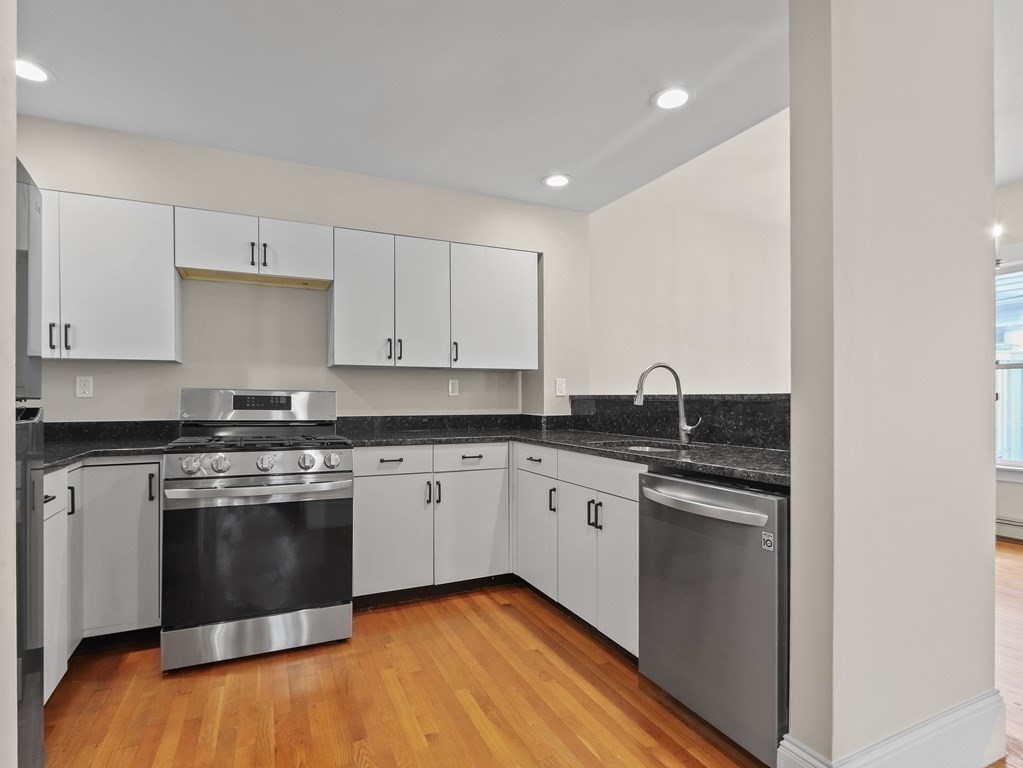 50 Roberts Road Cambridge, MA 02138 - Photo 7 of 25 a kitchen with stainless steel appliances granite countertop a stove and a sink