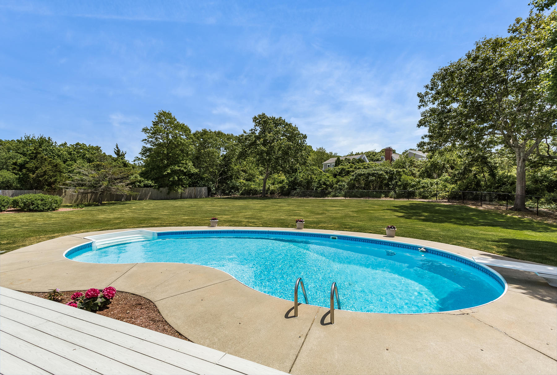 40 Torrey Road East Sandwich, MA 02537 - Photo 50 of 53 a view of a swimming pool and trees in the background