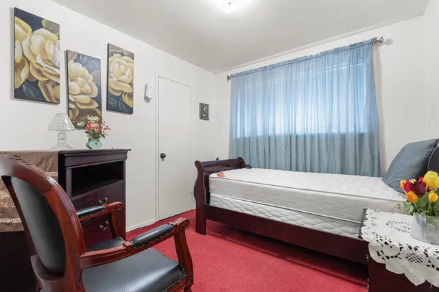 a bedroom with furniture and a window