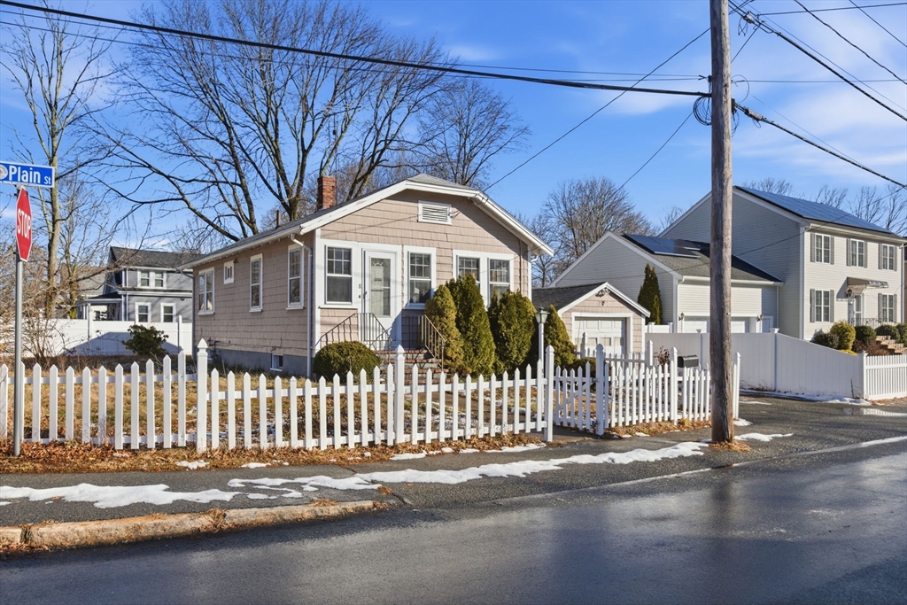 a front view of a house with a street