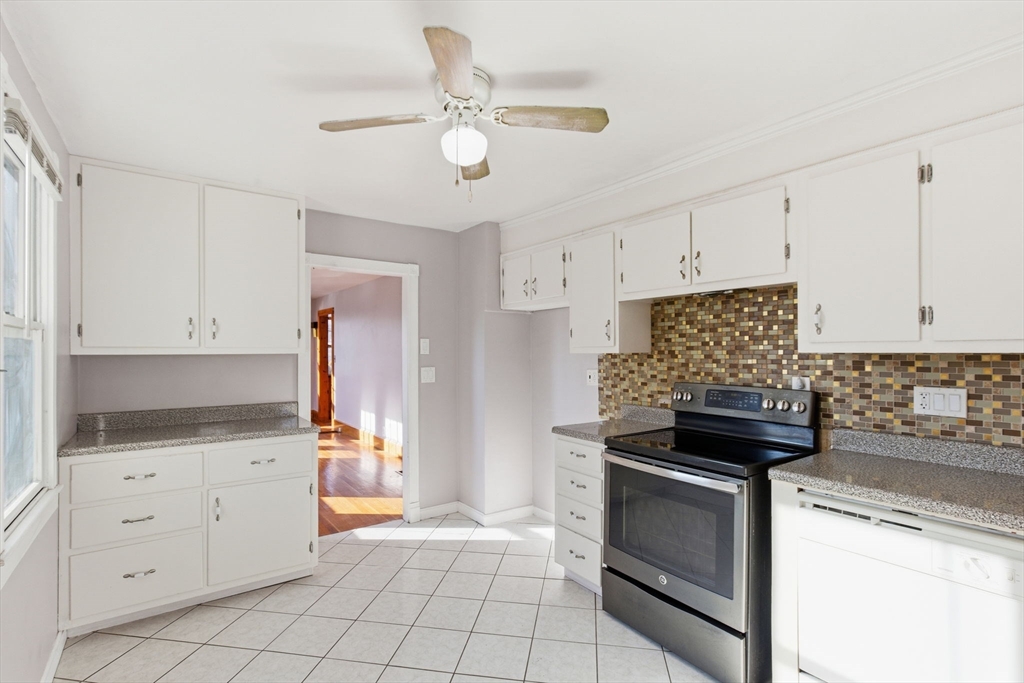 8 Plain Street Randolph, MA 02368 - Photo 15 of 38 a kitchen with white cabinets and appliances