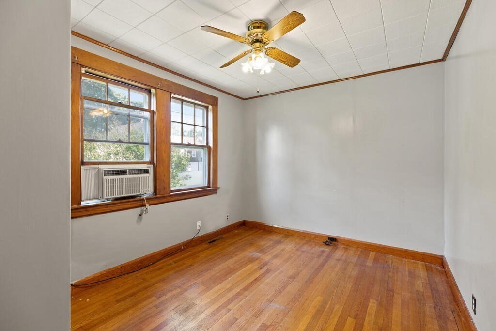 8 Plain Street Randolph, MA 02368 - Photo 16 of 25 an empty room with a window and a ceiling fan