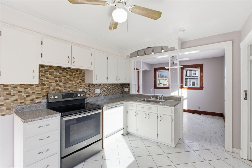 8 Plain Street Randolph, MA 02368 - Photo 16 of 38 a kitchen with a stove cabinets and window