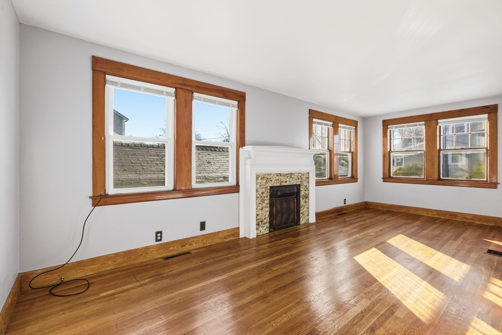 8 Plain Street Randolph, MA 02368 - Photo 10 of 38 a view of empty room with a fireplace and windows