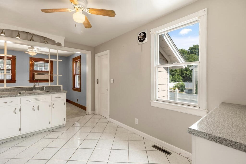 8 Plain Street Randolph, MA 02368 - Photo 10 of 25 a spacious bathroom with a granite countertop sink a mirror and a shower