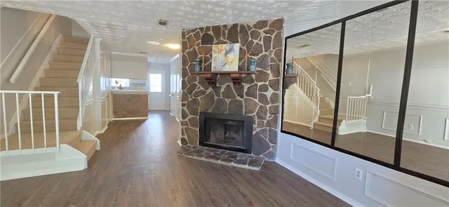 a view of front door and hallway with wooden floor