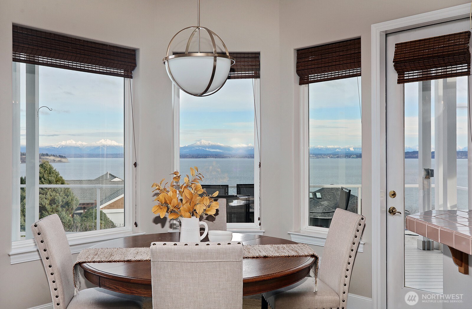 4694 Wrightsman Place Clinton, WA 98236 - Photo 6 of 38 a dining room with furniture a chandelier and wooden floor