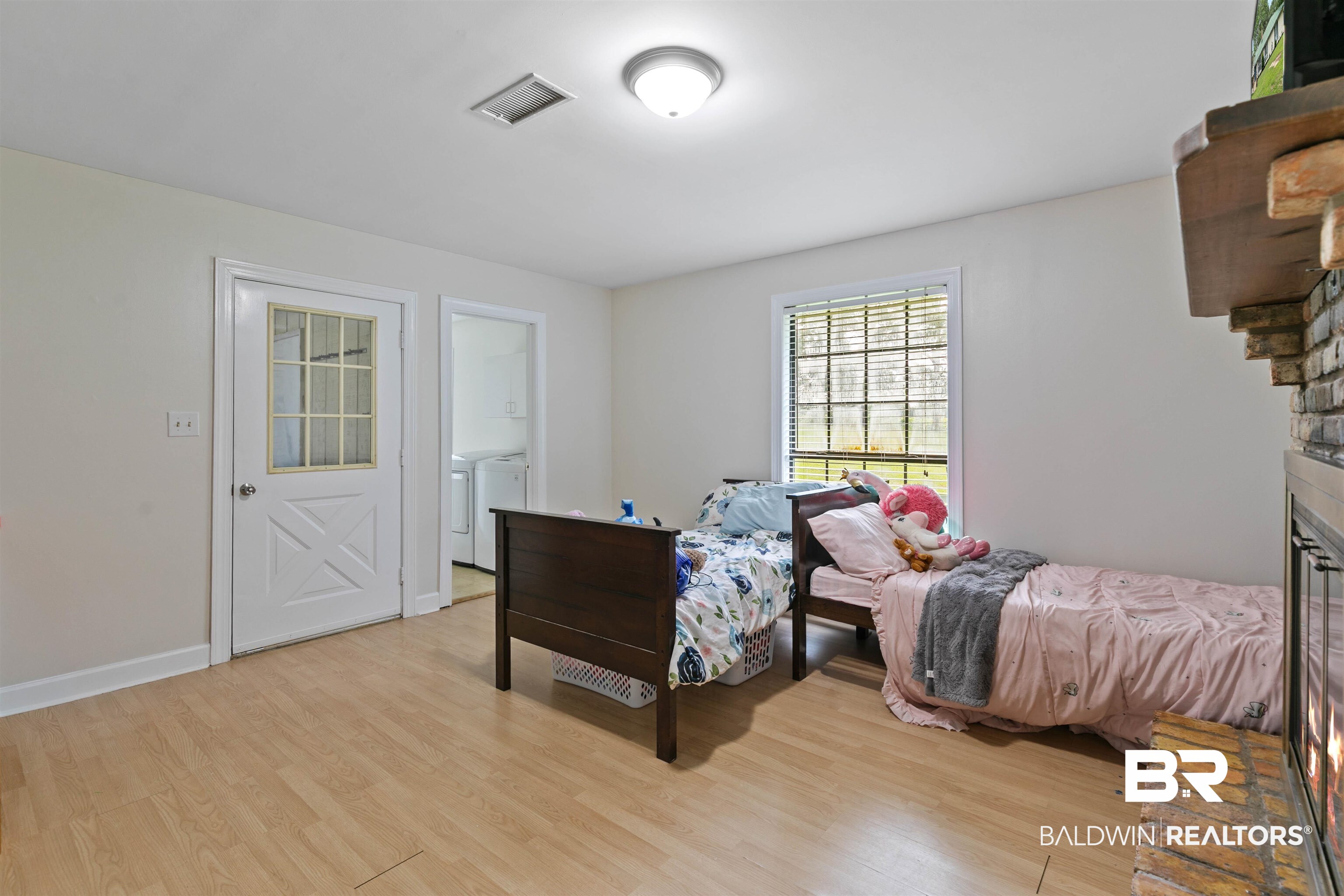10420 Johnson Road South Mobile, AL 36695 - Photo 26 of 75 Spacious room featuring wood-finish flooring, a white paneled door with glass inserts, and a window with horizontal blinds