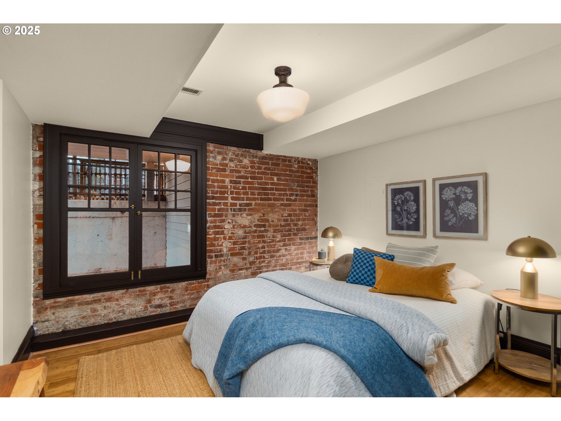 333 Northwest 20th Avenue, Unit 2 Portland, OR 97209 - Photo 22 of 28 a bedroom with a large bed and a chandelier