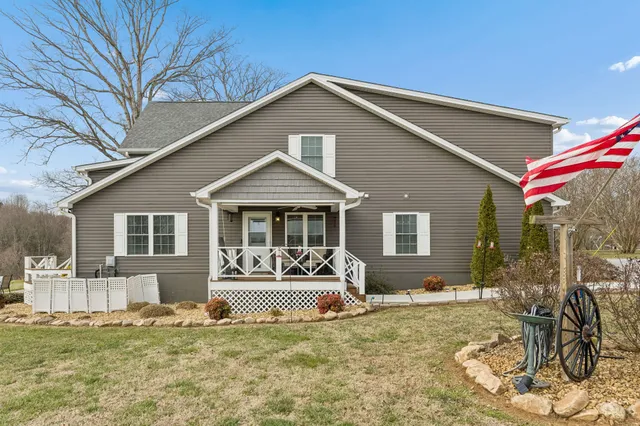 a front view of a house with a yard outdoor seating and garage