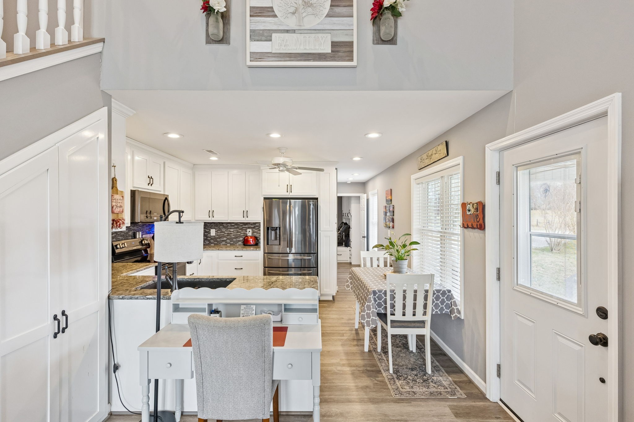 403 Bland Road Estill Springs, TN 37330 - Photo 12 of 53 a living room with kitchen island furniture and a dining table with kitchen view