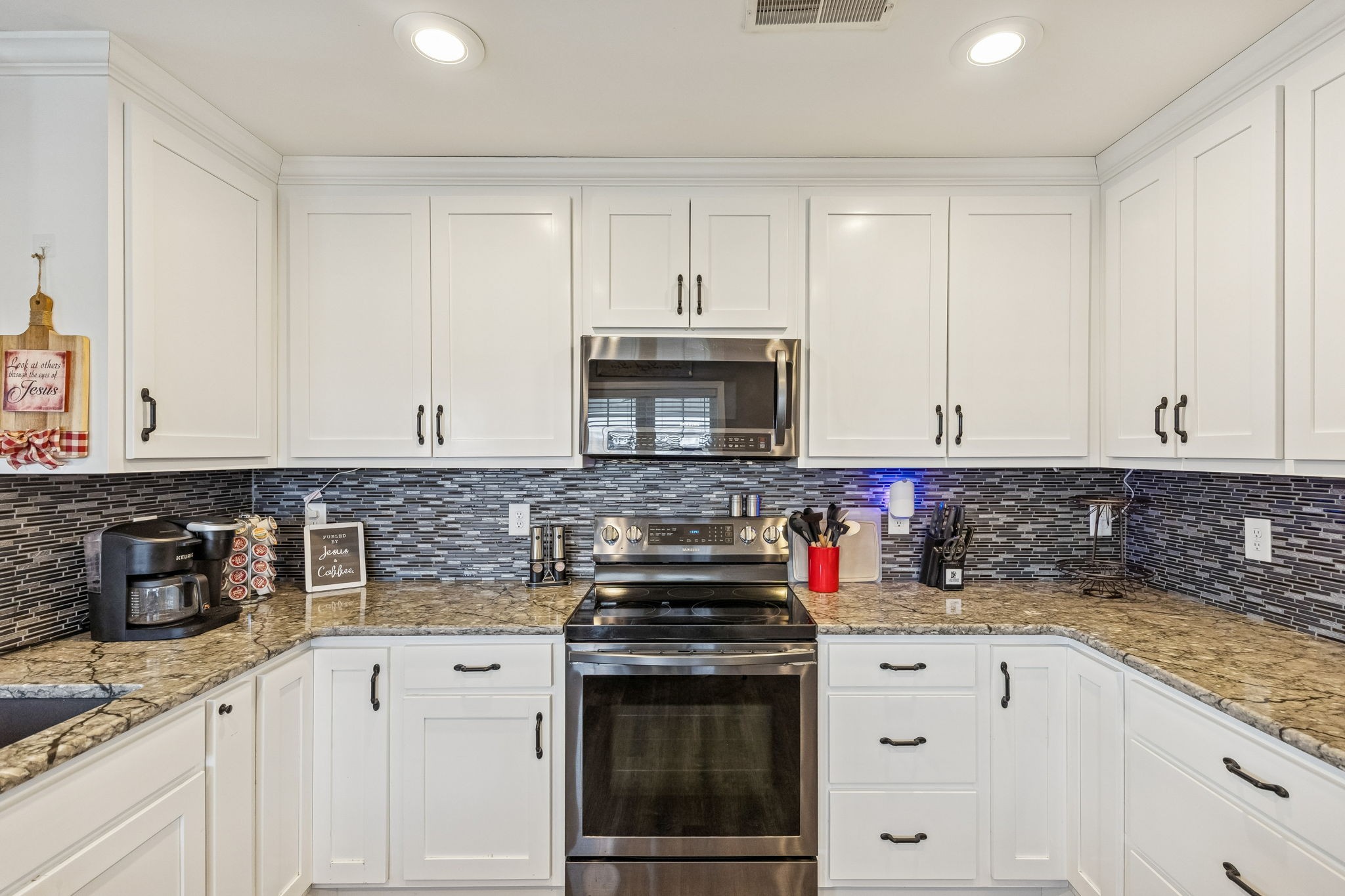 403 Bland Road Estill Springs, TN 37330 - Photo 15 of 53 a kitchen with stainless steel appliances granite countertop a stove a sink and a white cabinets