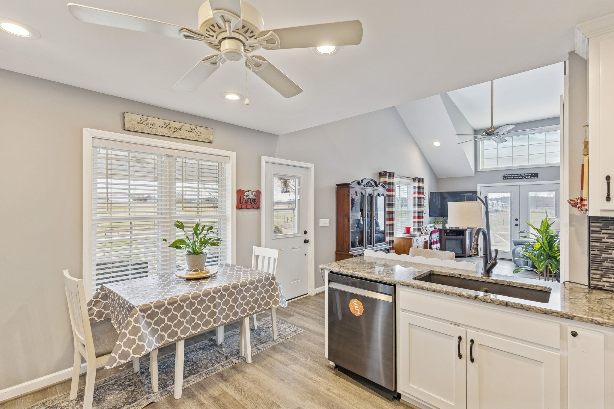 403 Bland Road Estill Springs, TN 37330 - Photo 16 of 53 a kitchen with a table chairs refrigerator and chandelier