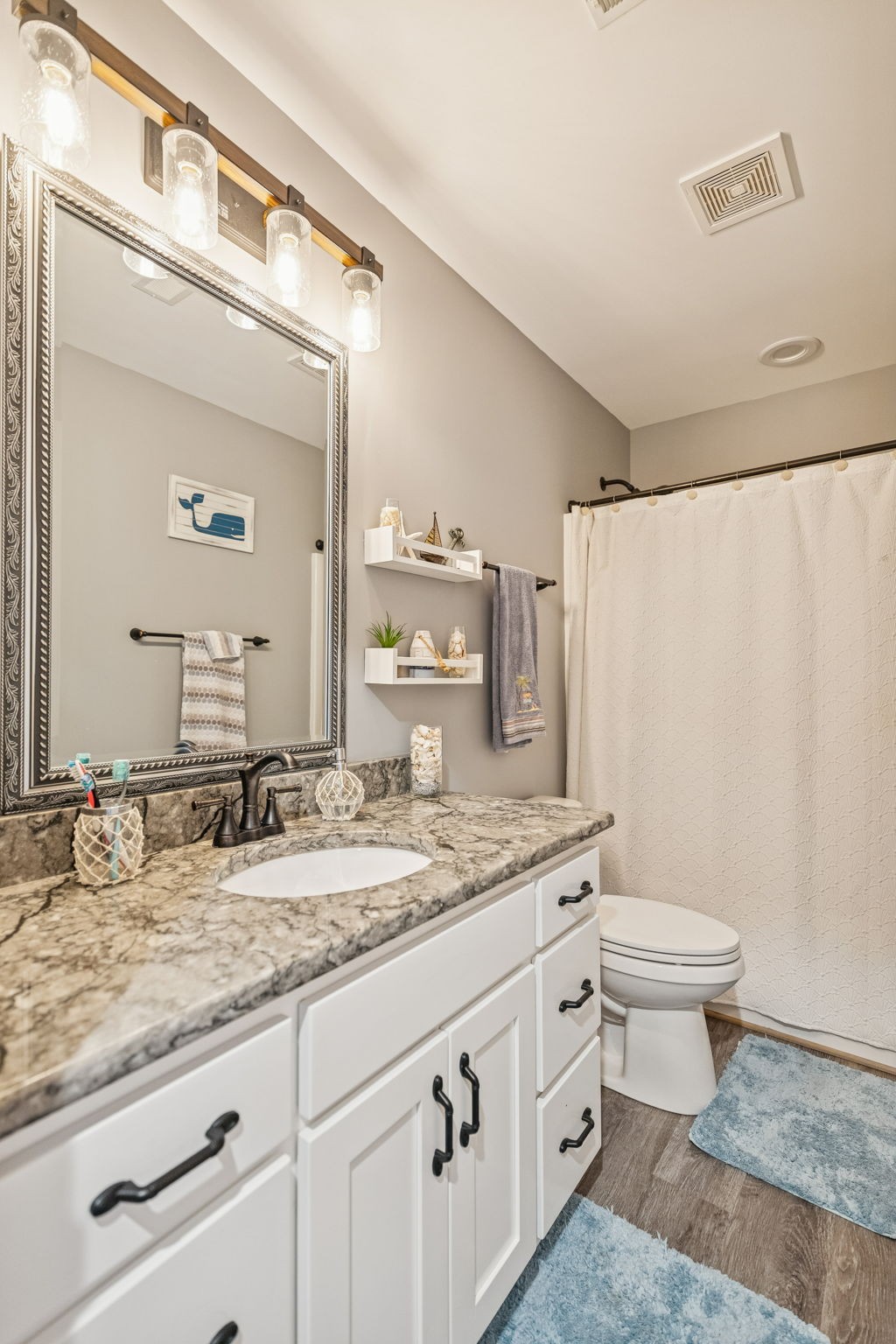 403 Bland Road Estill Springs, TN 37330 - Photo 34 of 53 a bathroom with a granite countertop sink a toilet and a mirror