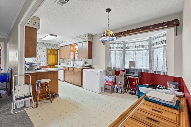 a kitchen that has a lot of cabinets in it