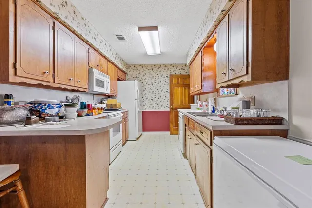 a kitchen with stainless steel appliances granite countertop a sink and cabinets