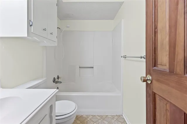 a bathroom with a sink toilet vanity and tub