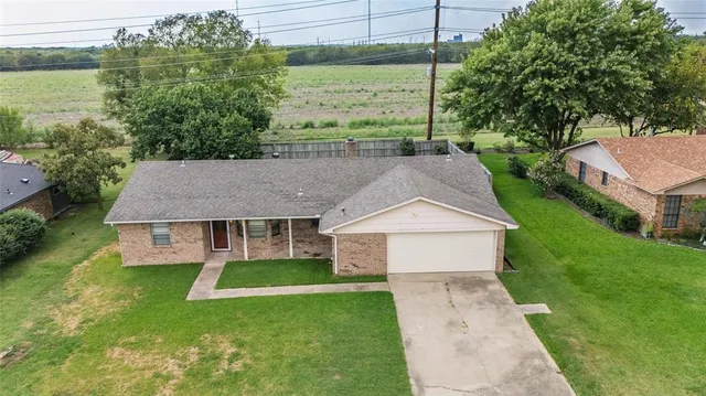 a aerial view of a house with a yard table and chairs