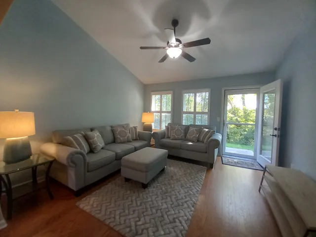 a living room with furniture and a large window
