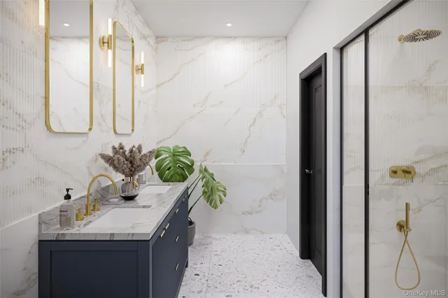 a bathroom with a granite countertop sink a mirror and a shower