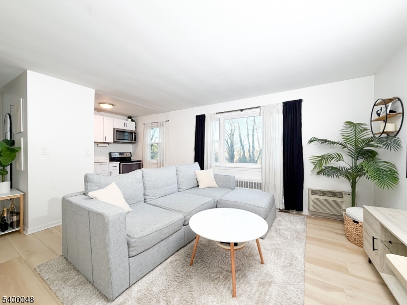300 Wilson Road, Unit 24D Springfield, NJ 07081 - Photo 2 of 11 a living room with furniture and a large window
