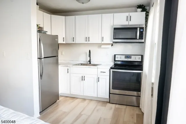a kitchen with stainless steel appliances a refrigerator stove and microwave