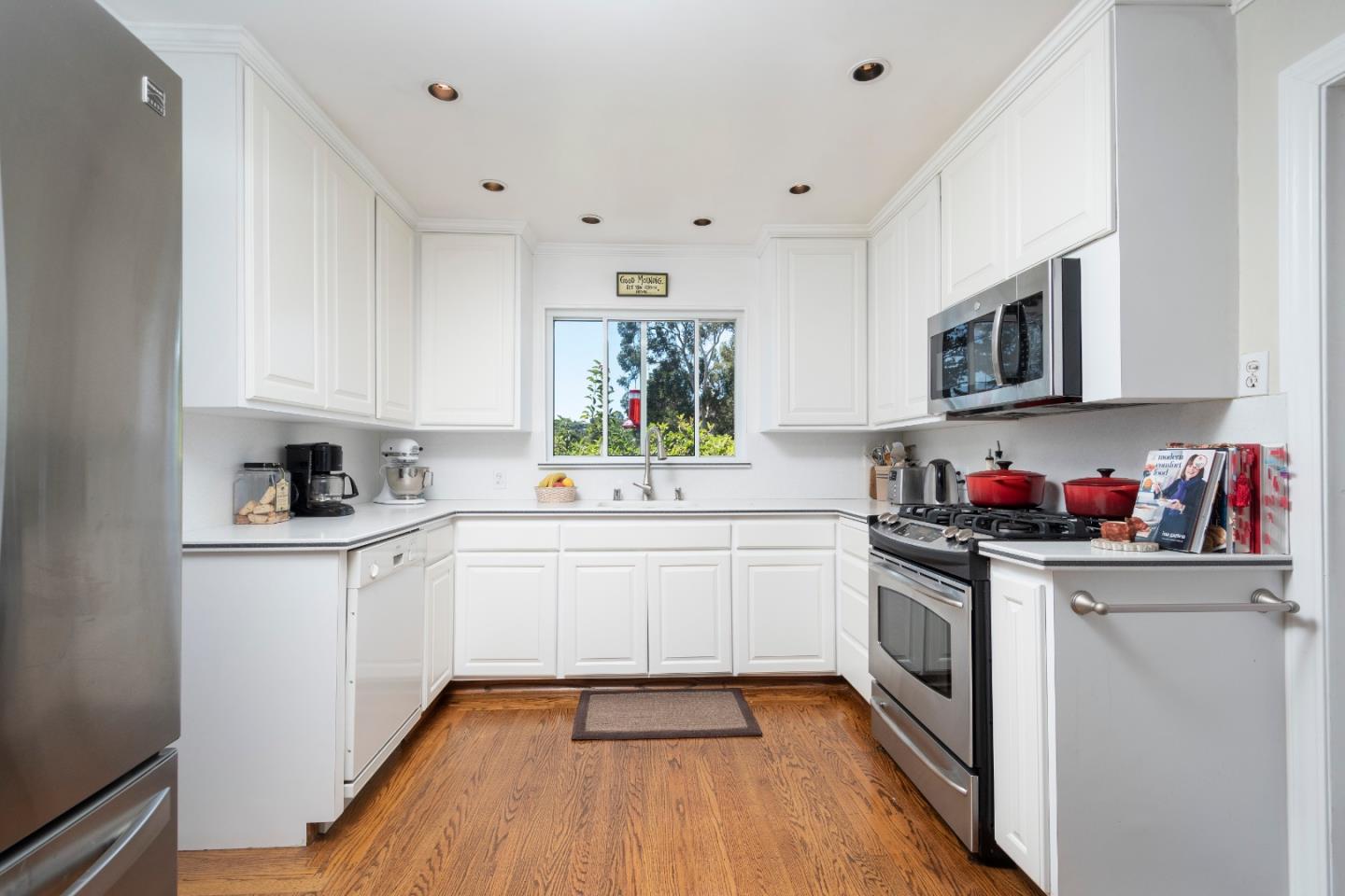 9 La Mancha Place Millbrae, CA 94030 - Photo 5 of 20 a kitchen with granite countertop a sink cabinets stainless steel appliances and wooden floor