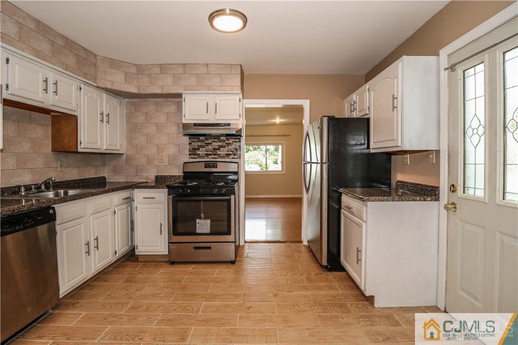 20 Sturgis Road Edison, NJ 08817 - Photo 11 of 25 a kitchen with stainless steel appliances a stove a sink and a refrigerator