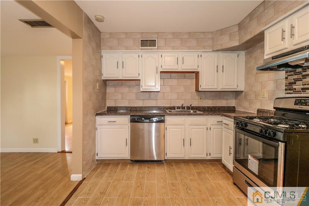 20 Sturgis Road Edison, NJ 08817 - Photo 12 of 25 a kitchen with cabinets appliances and wooden floor
