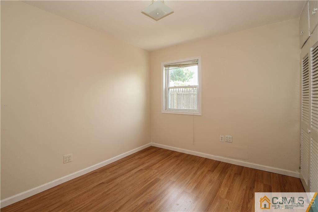 20 Sturgis Road Edison, NJ 08817 - Photo 17 of 25 an empty room with a hardwood and a window