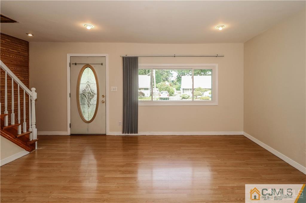 20 Sturgis Road Edison, NJ 08817 - Photo 2 of 25 an empty room with wooden floor and window