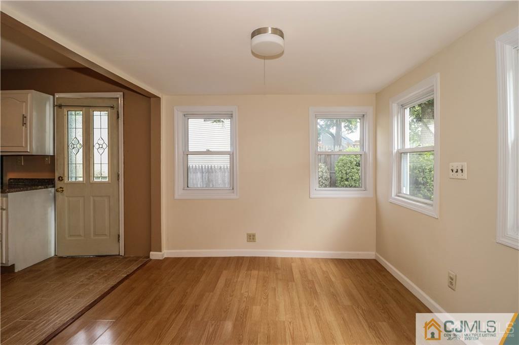 20 Sturgis Road Edison, NJ 08817 - Photo 5 of 25 an empty room with wooden floor and windows
