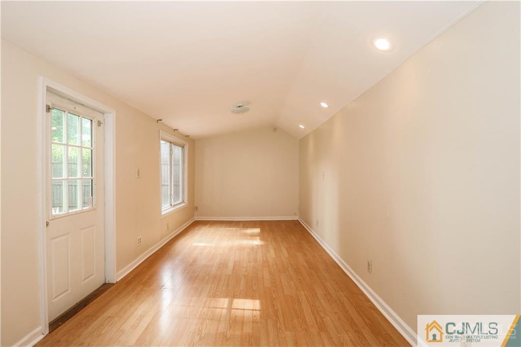 20 Sturgis Road Edison, NJ 08817 - Photo 7 of 25 a view of an empty room with wooden floor and a window