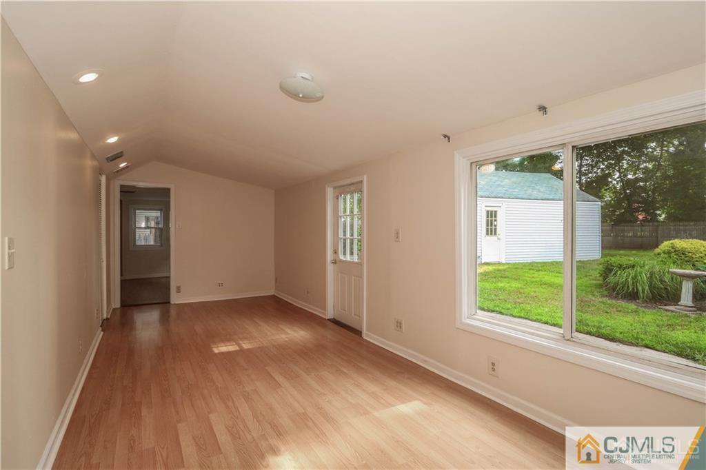 20 Sturgis Road Edison, NJ 08817 - Photo 8 of 25 an empty room with wooden floor and windows