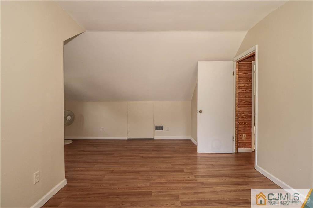 20 Sturgis Road Edison, NJ 08817 - Photo 10 of 25 a view of an empty room with wooden floor