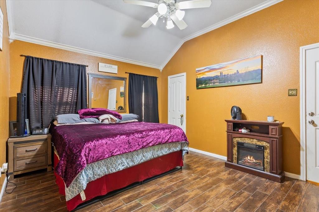 736 Tahoe Trail Hewitt, TX 76643 - Photo 14 of 30 Bedroom with ornamental molding, lofted ceiling, a textured wall, wood finish floors, and a ceiling fan