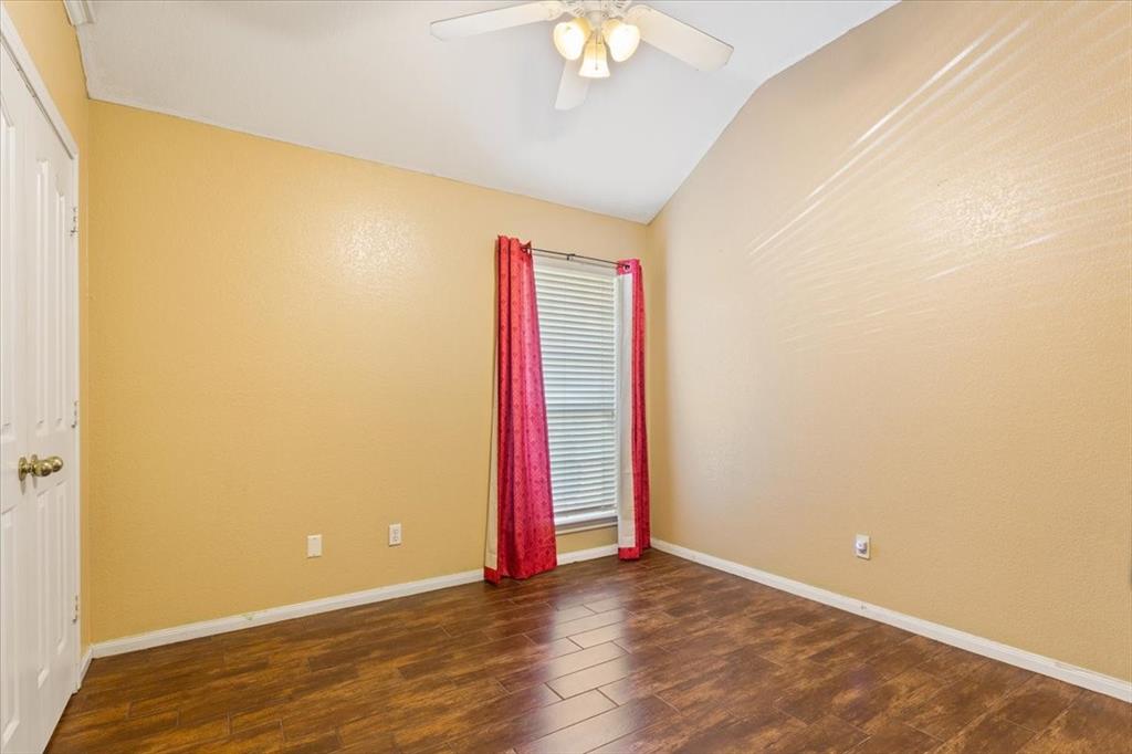 736 Tahoe Trail Hewitt, TX 76643 - Photo 23 of 30 Empty room featuring dark wood-style flooring, lofted ceiling, and a ceiling fan
