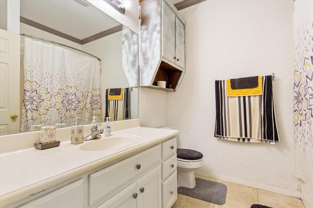 736 Tahoe Trail Hewitt, TX 76643 - Photo 24 of 30 Full bath featuring vanity, light tile patterned floors, curtained shower, and a textured wall