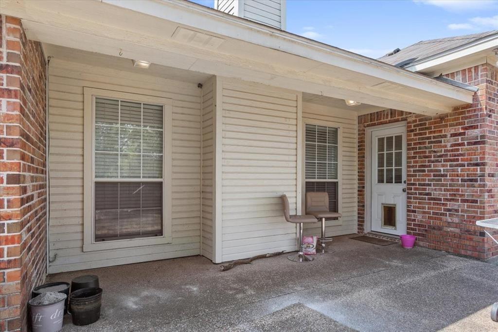 736 Tahoe Trail Hewitt, TX 76643 - Photo 25 of 30 Entrance to property featuring brick siding, a patio area, and a chimney