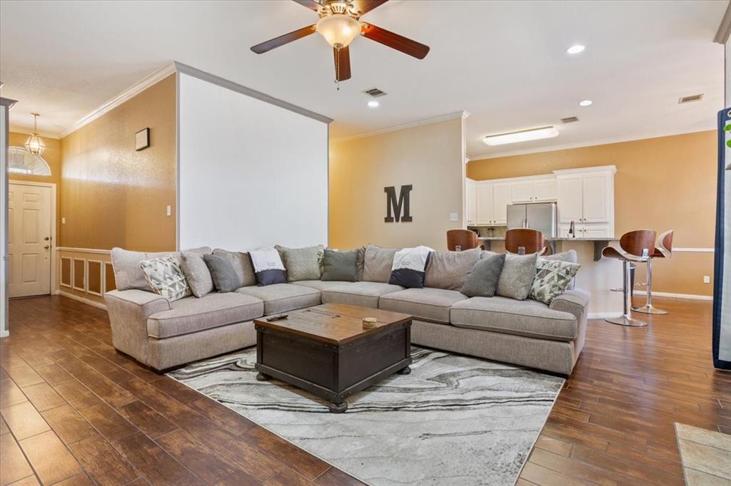 736 Tahoe Trail Hewitt, TX 76643 - Photo 8 of 30 Living area with ornamental molding, dark wood-type flooring, a ceiling fan, and recessed lighting