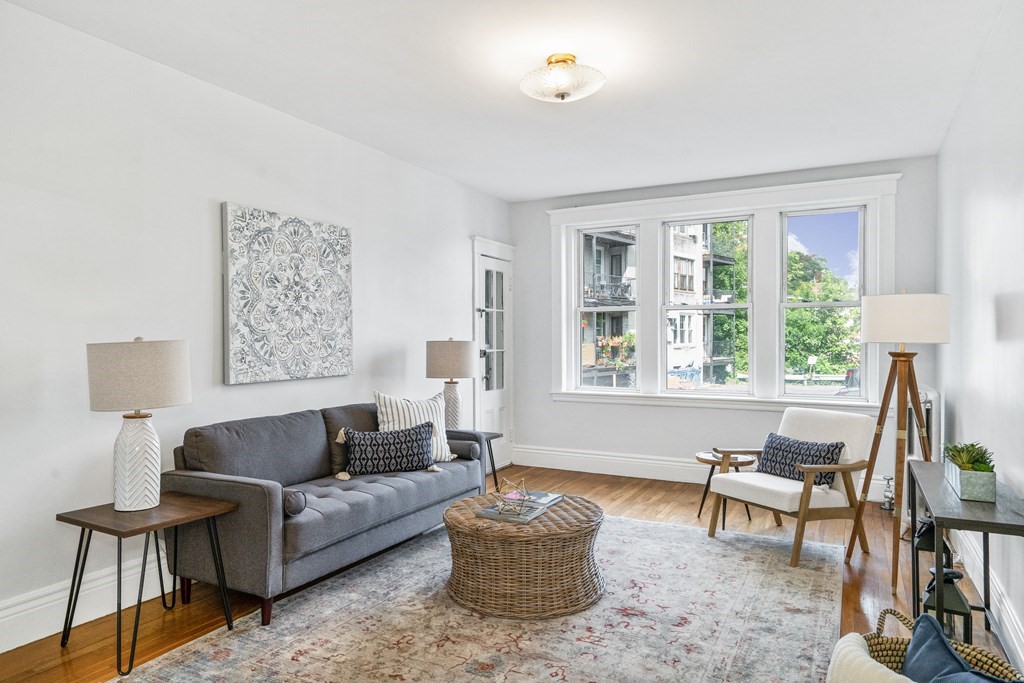 8 Kinross Road, Unit 4 Boston, MA 02135 - Photo 1 of 13 a living room with furniture and a large window
