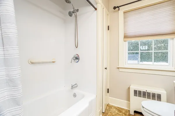 a bathroom with a bathtub and a shower