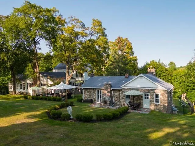 a front view of a house with a garden and trees