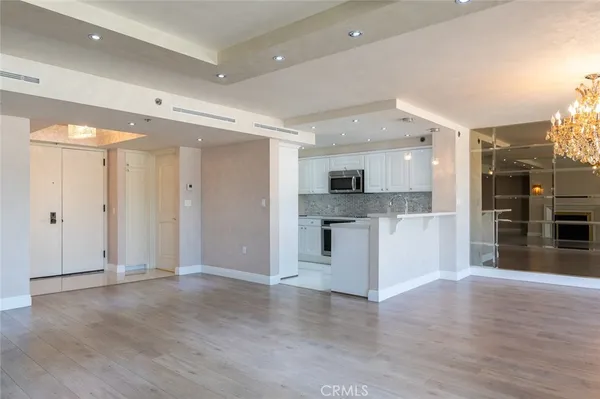 a kitchen with granite countertop white cabinets and stainless steel appliances