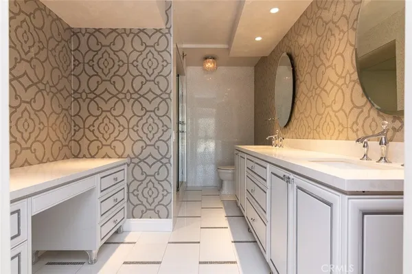 a bathroom with a sink a mirror and a toilet