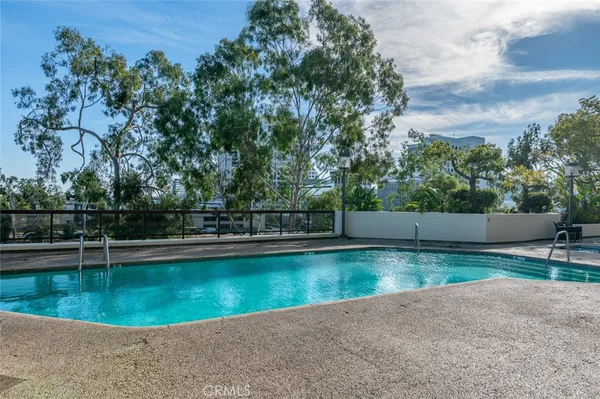 a view of swimming pool with outdoor seating and plants
